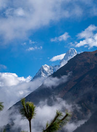 Low angle view of snowcapped mountains against sky