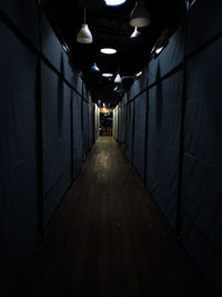 Empty corridor in illuminated building