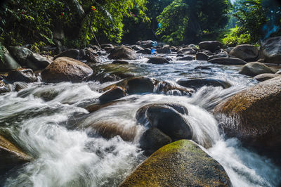 Scenic view of river flowing through rocks