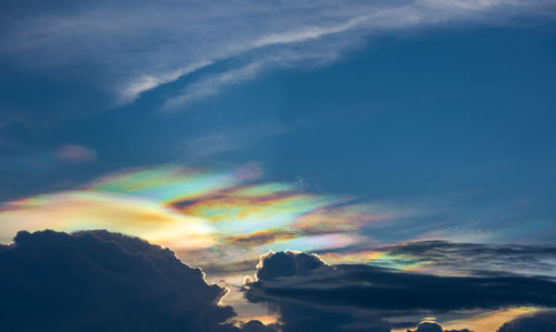 Low angle view of rainbow against sky during sunset