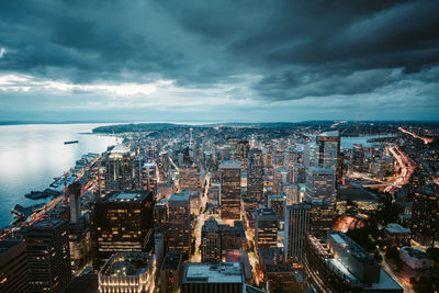 Aerial view of illuminated city against sky