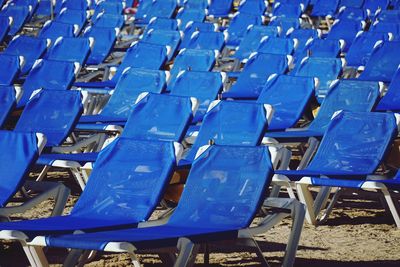 Empty blue chairs at beach