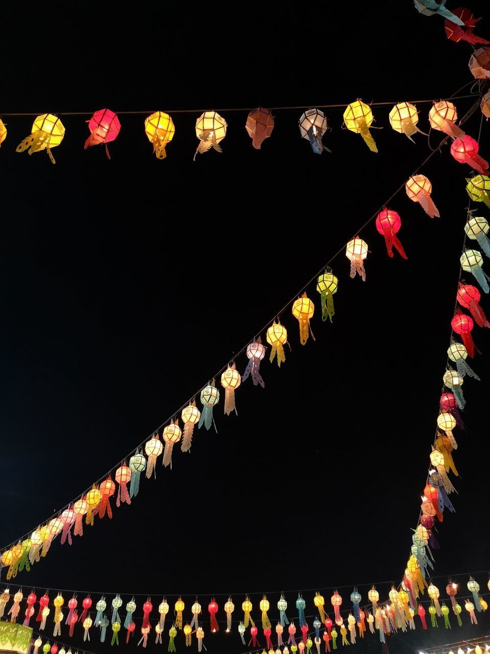 LOW ANGLE VIEW OF ILLUMINATED LANTERNS AGAINST SKY