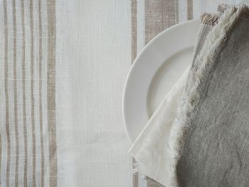 High angle view of napkins in plate on table