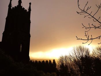 Silhouette of statue against sky at sunset