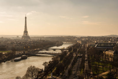 Aerial view of city against cloudy sky