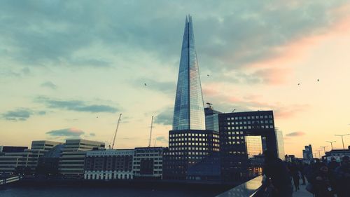 Buildings against cloudy sky during sunset