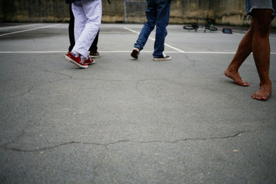 Low section of people walking on street