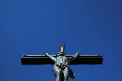 Low angle view of statue against clear blue sky