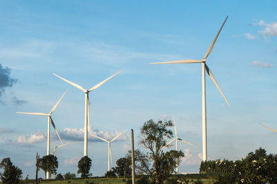 Windmill on field against sky