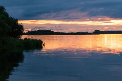 Scenic view of lake against orange sky