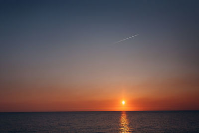 Scenic view of sea against orange sky