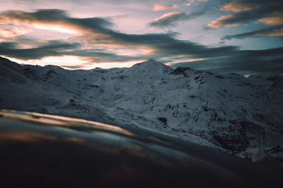 Scenic view of snowcapped mountains against sky during sunset