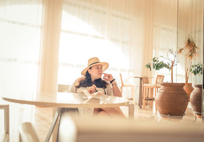 Portrait of young woman sitting at hotel lounge 