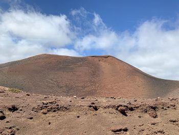 Scenic view of arid landscape against sky