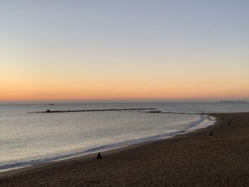 Scenic view of sea against clear sky during sunset