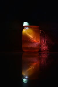 Close-up of wineglass on table against black background