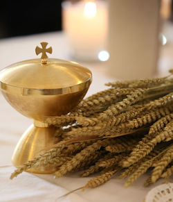 Golden chalice on an altar in a church with ears of wheat a religious symbol of christianity