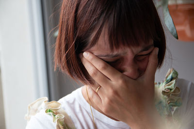 Close-up of young woman at home