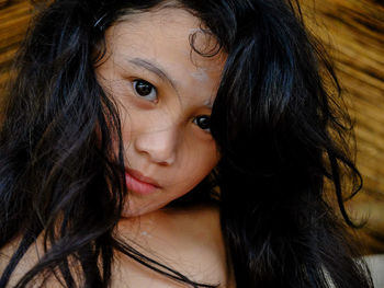 Close-up portrait of smiling young woman