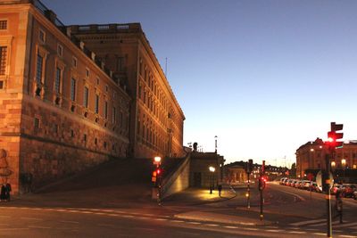 View of road along buildings at night