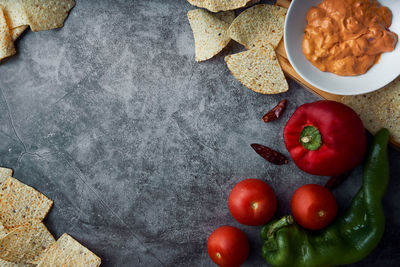 Kitchen background frame with copy space with tomato, pepper, spicy, mexican cheese sauce and nachos