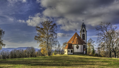 View of chapel on field against sky