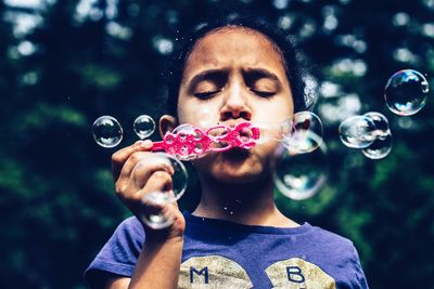 Portrait of mature man holding bubbles