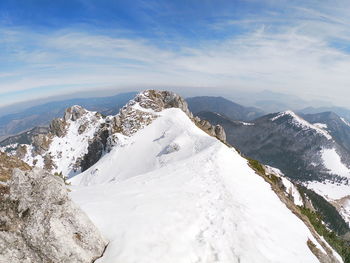Scenic view of snowcapped mountains against sky