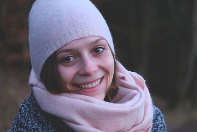 Close-up portrait of smiling woman in warm clothing