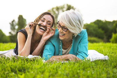 Happy woman lying on grass