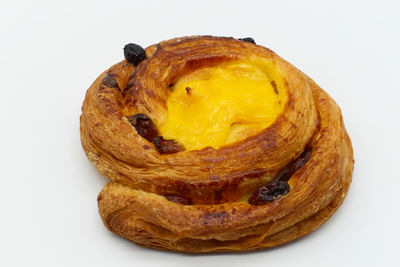 Close-up of bread in plate against white background