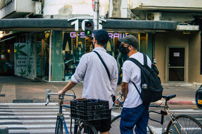 Rear view of people on street in city