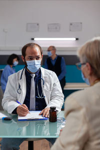 Portrait of doctor examining patient in laboratory
