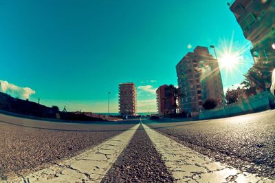 Road by city against clear sky