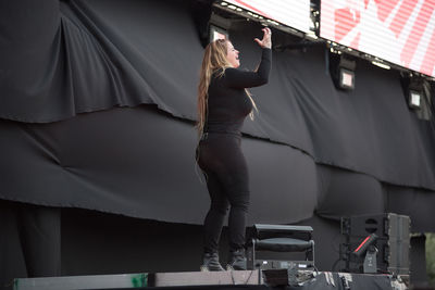 Rear view of woman standing in corridor