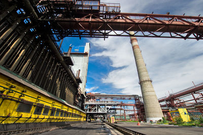 Low angle view of smoke stack against sky at factory