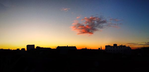 Silhouette cityscape against sky during sunset