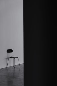 Empty chair against wall at home