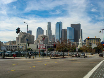 City street and buildings against sky