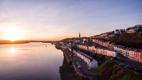 View of bridge over river at sunset