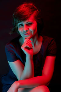 Portrait of woman sitting in darkroom