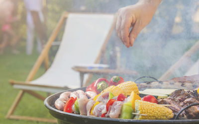 Cropped hand of person preparing food