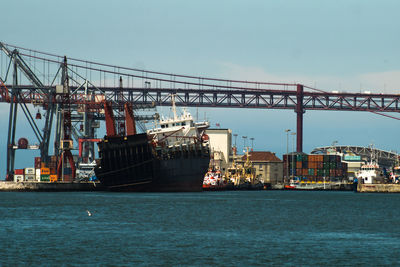 View of illuminated commercial dock against sky