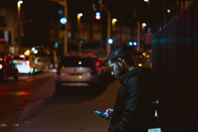 Man using smart phone at night