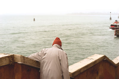 Rear view of woman standing in water