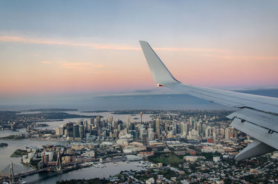 View of sydney out of a plane window at sunset