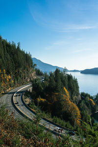 High angle view of road by trees against sky