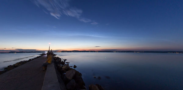 Scenic view of sea against sky at sunset