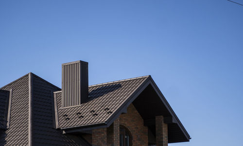 Low angle view of building against clear blue sky